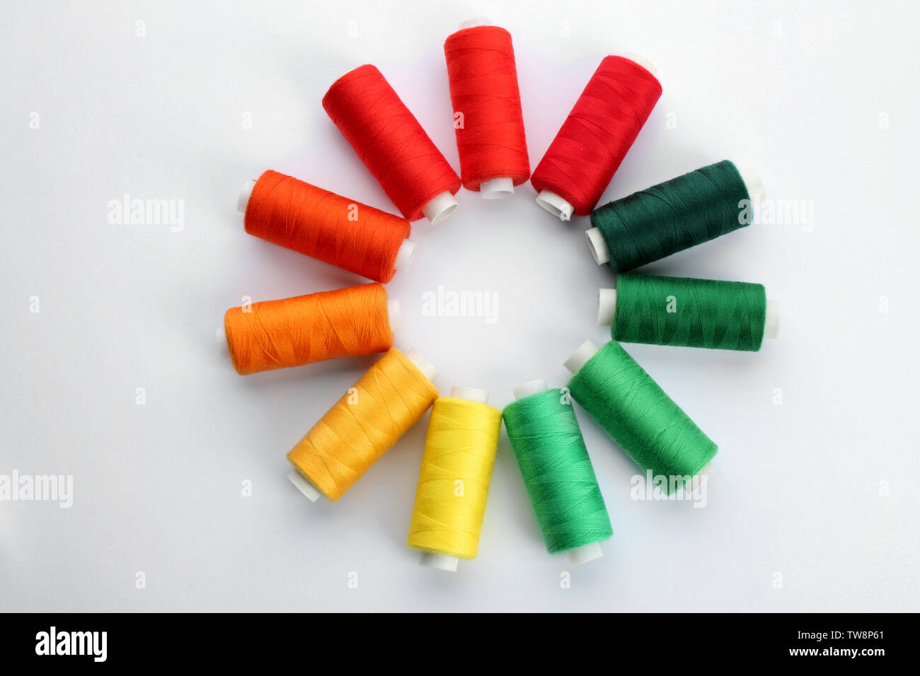 Colorful sewing threads on white background Stock Photo - Alamy