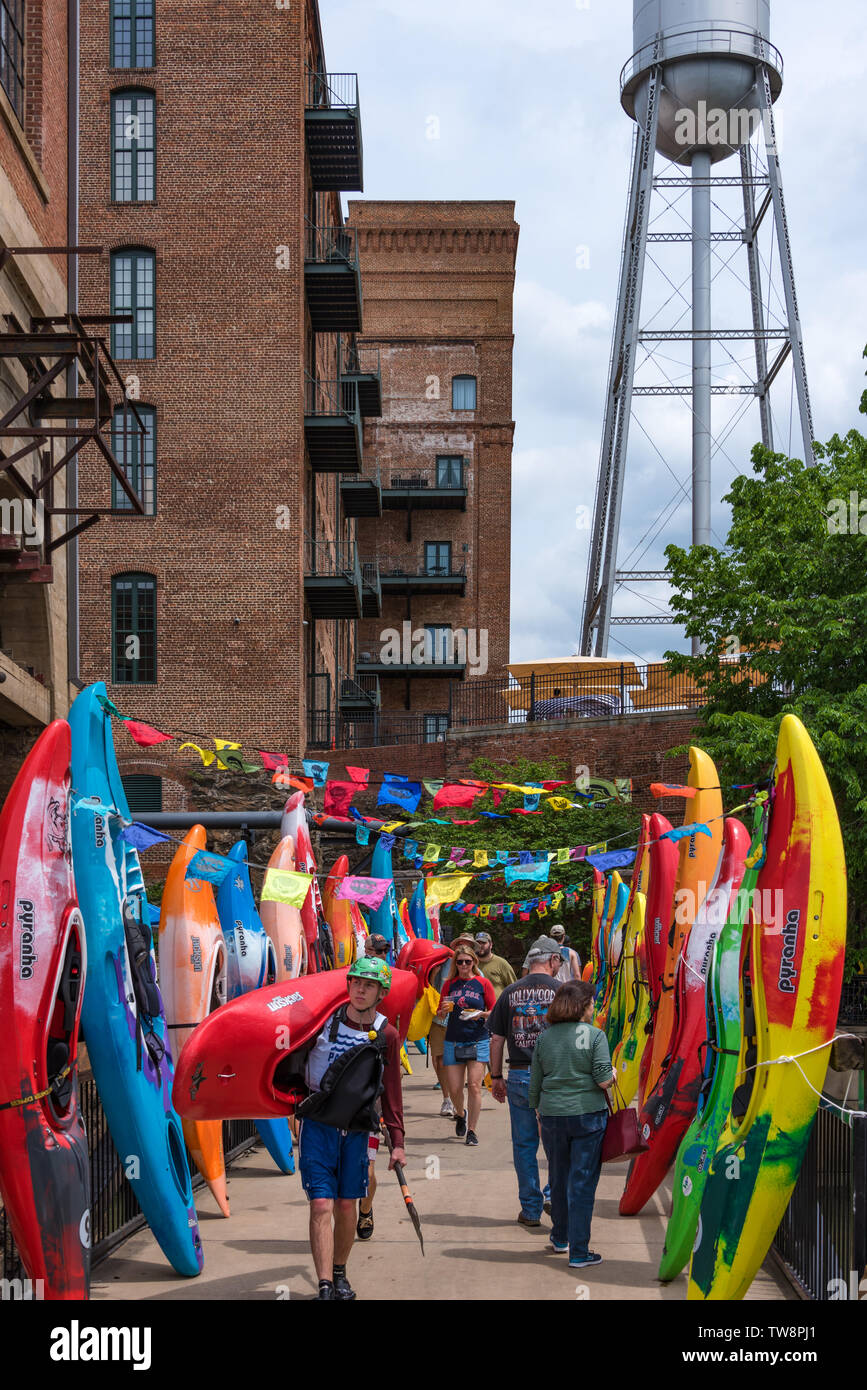 Colorful kayaks line the walkway from the Columbus RiverWalk to Paddle