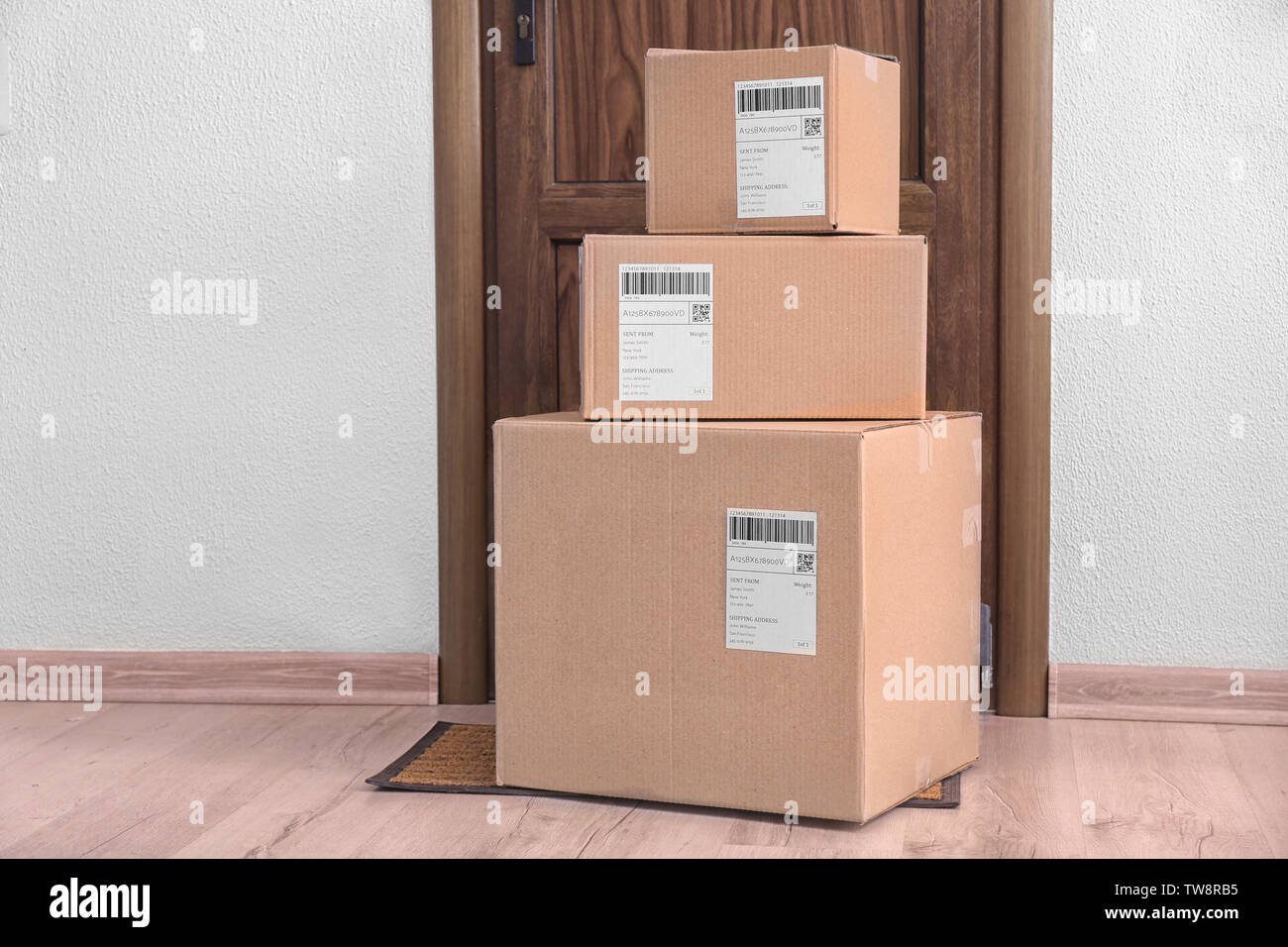 Parcel boxes on floor near door Stock Photo Alamy