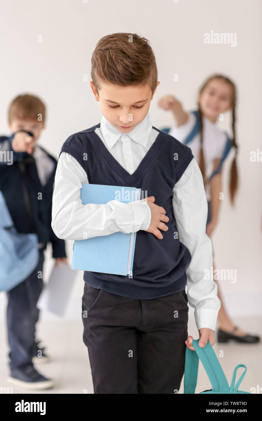 Children bullying their classmate on light background Stock Photo - Alamy