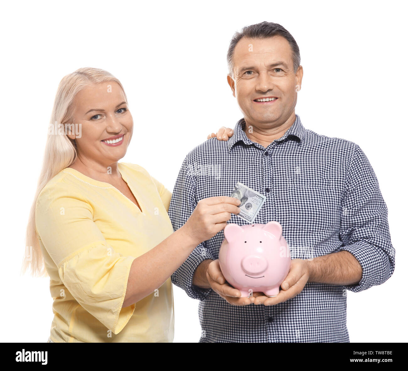 Mature couple with piggy bank on white background Stock Photo - Alamy