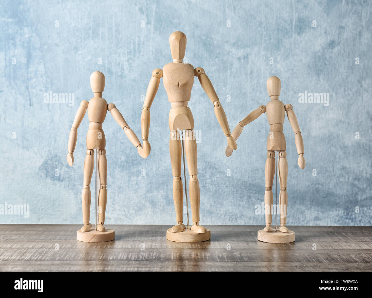 Wooden people holding hands together on table. Unity concept Stock ...