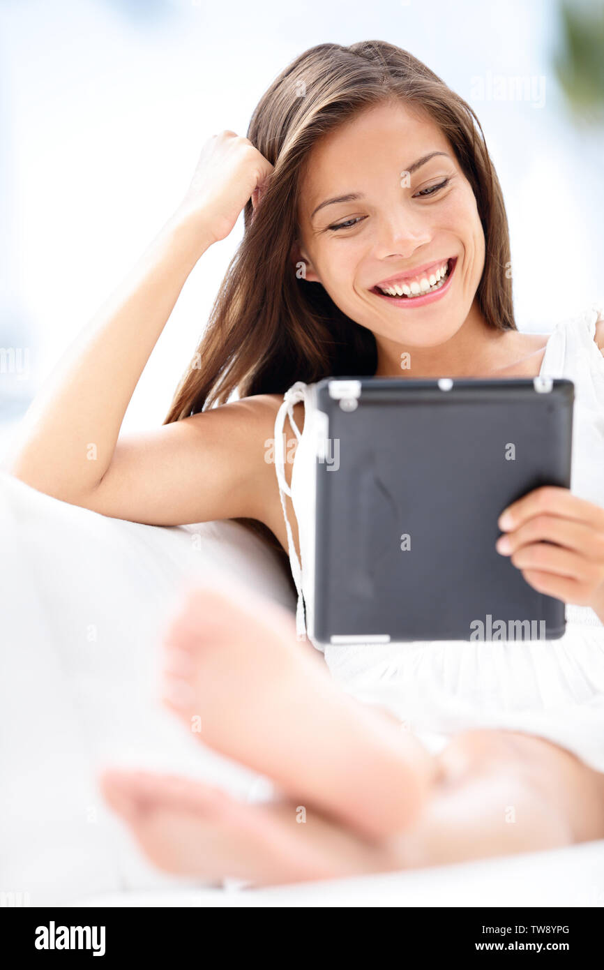 Tablet Computer Woman Young Smiling Mixed Race Reading Relaxed On