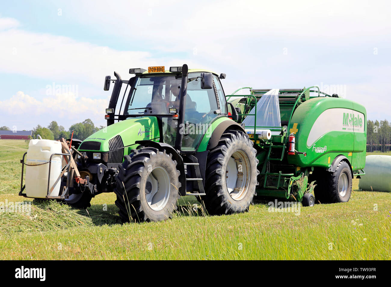 Salo, Finland. June 15, 2019. Farmer working with Deutz-Fahr Agrotron  tractor and McHale 3 plus integrated baler wrapper in hay field on day of  summer Stock Photo - Alamy
