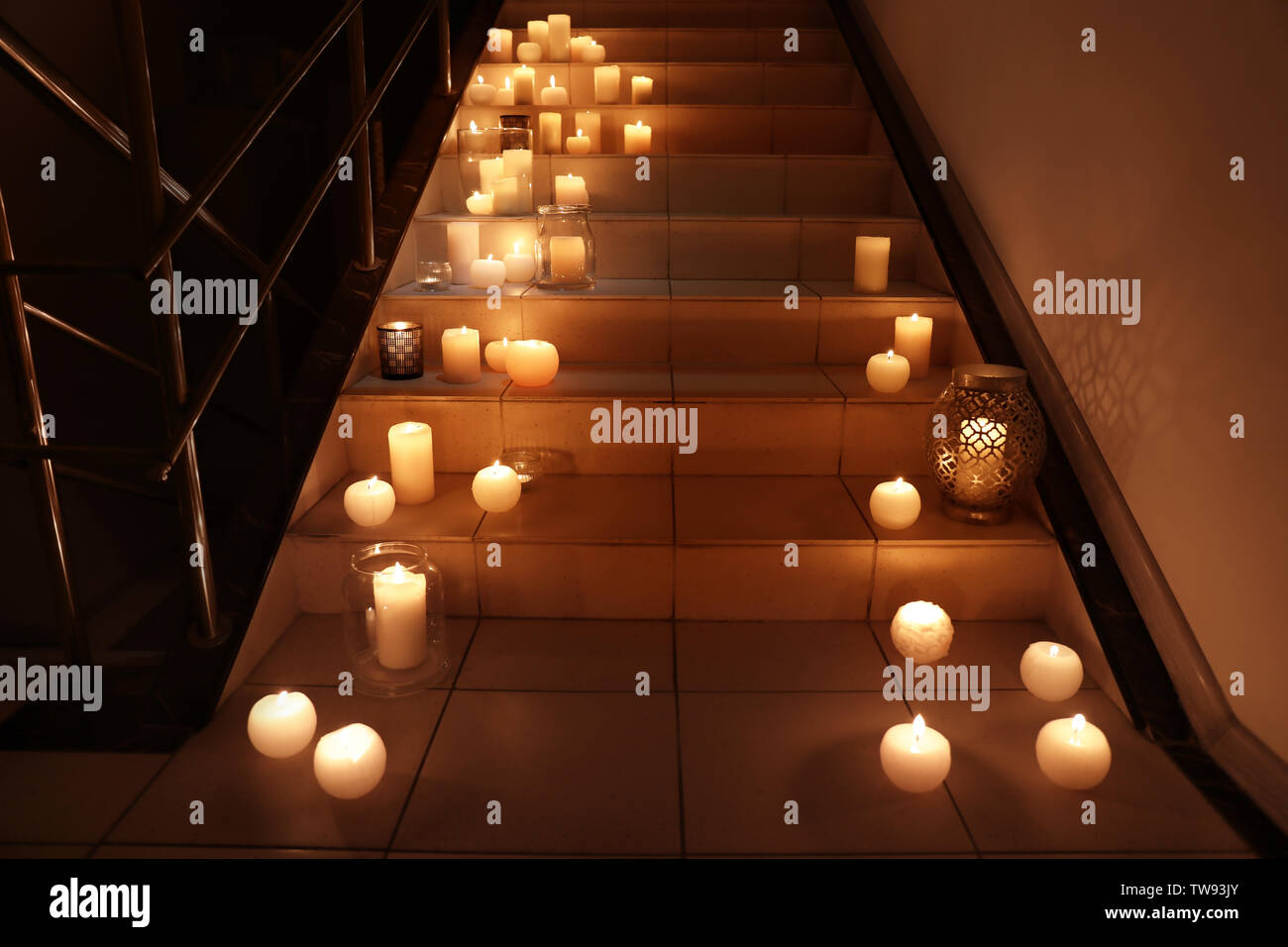 Burning candles on stairs Stock Photo Alamy
