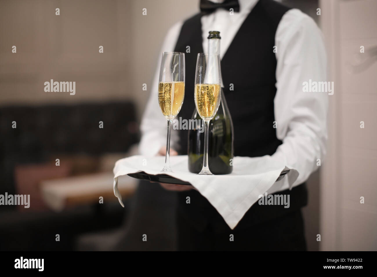 Waiter holding tray glasses bottle hi-res stock photography and images ...