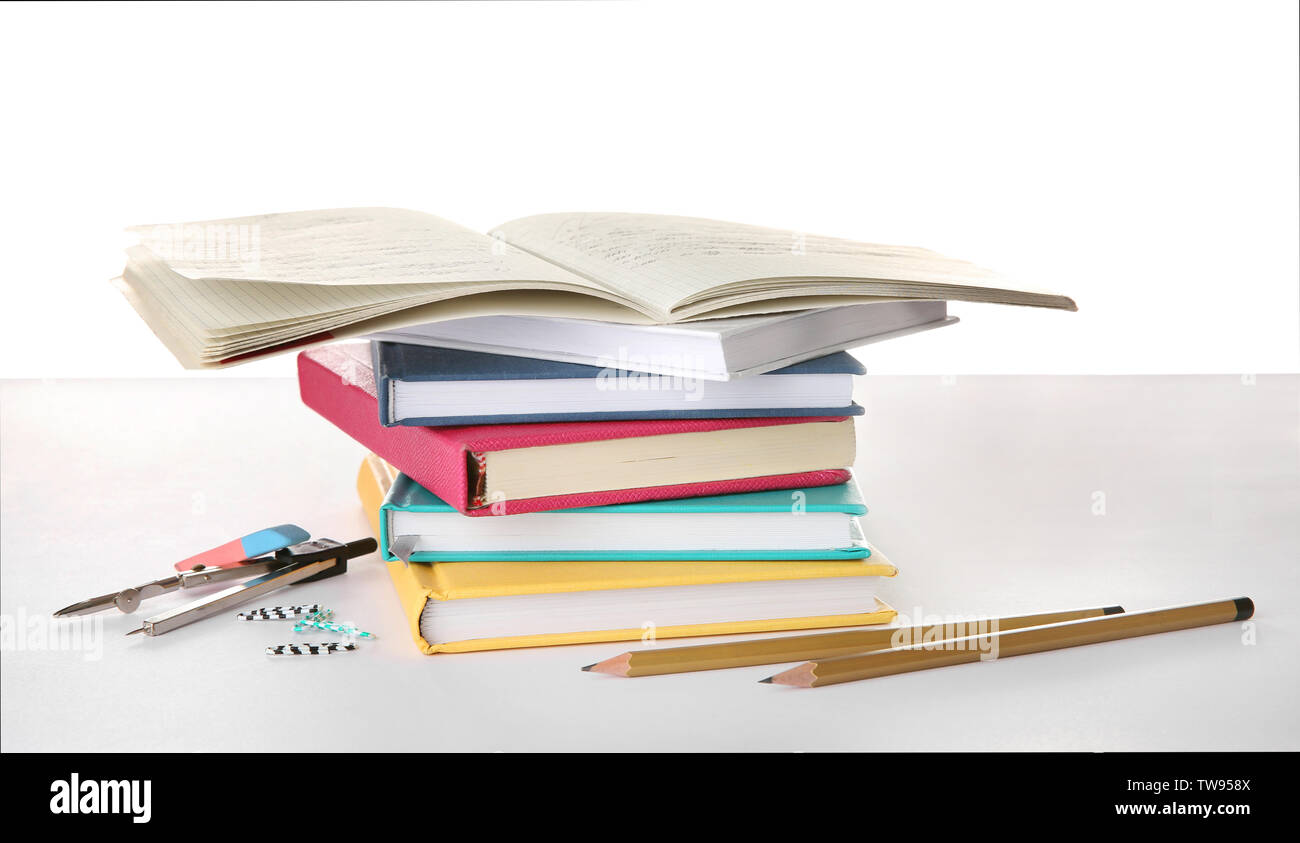 https://c8.alamy.com/comp/TW958X/stack-of-books-and-stationery-on-white-background-doing-homework-TW958X.jpg