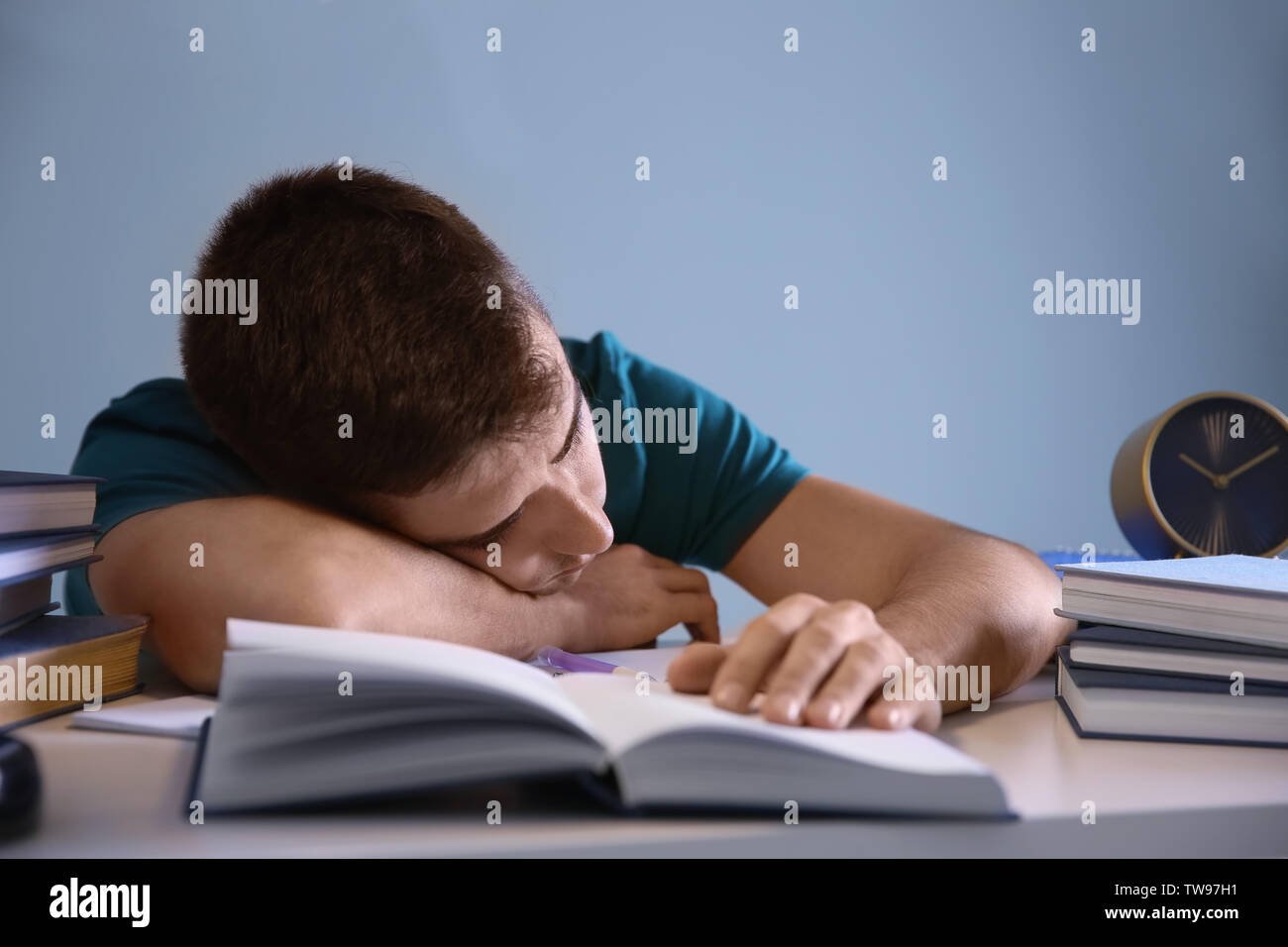 Tired Student Sleeping At His Desk Indoors Preparing For Exam