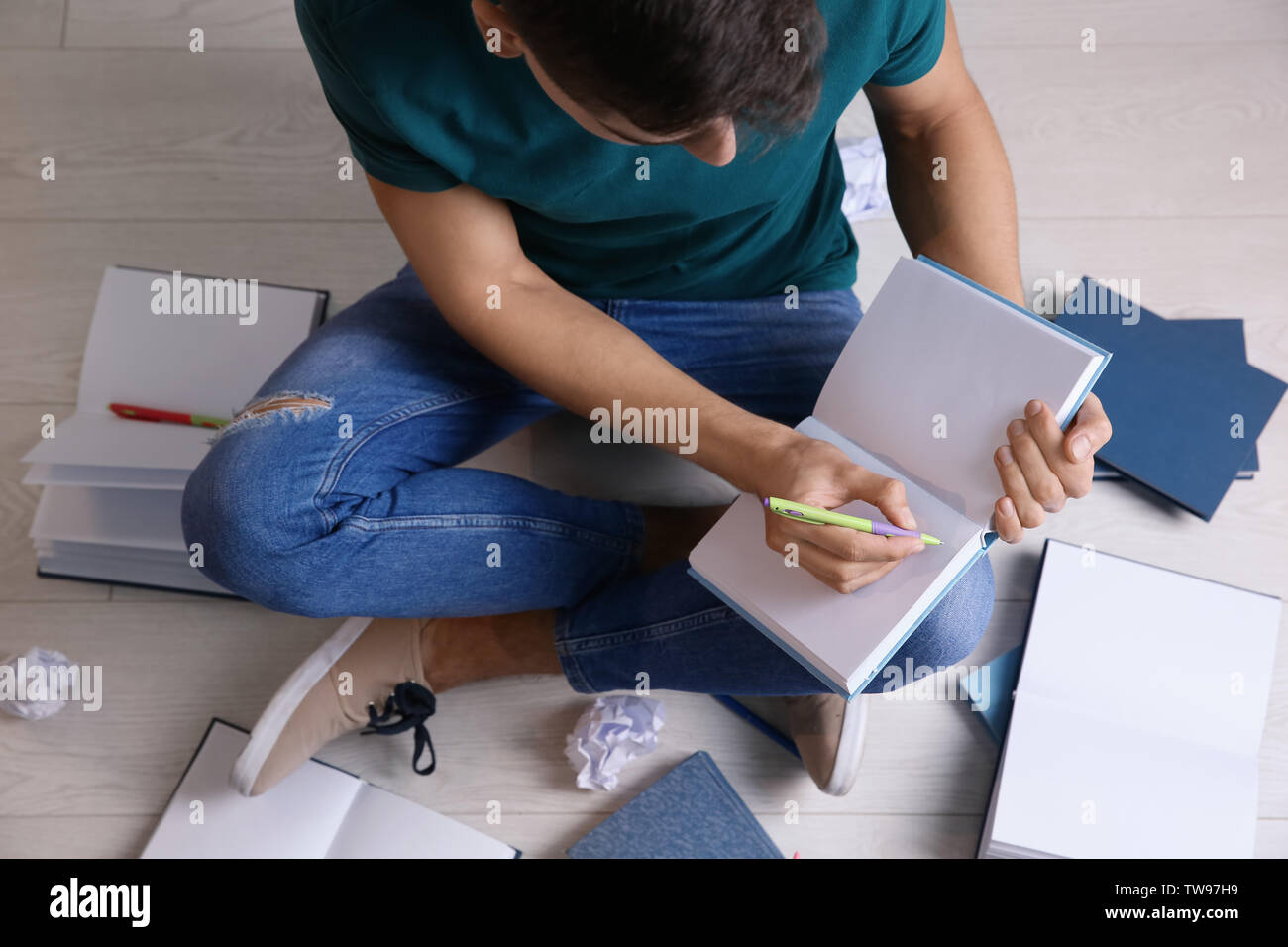 Male student preparing for exam indoors Stock Photo