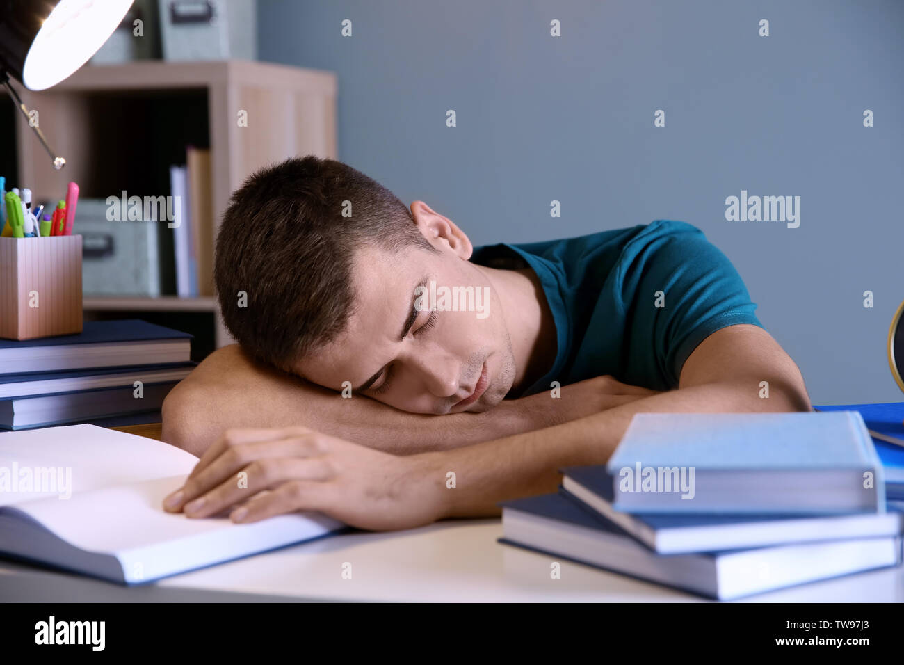 Tired Student Sleeping At His Desk Indoors Preparing For Exam
