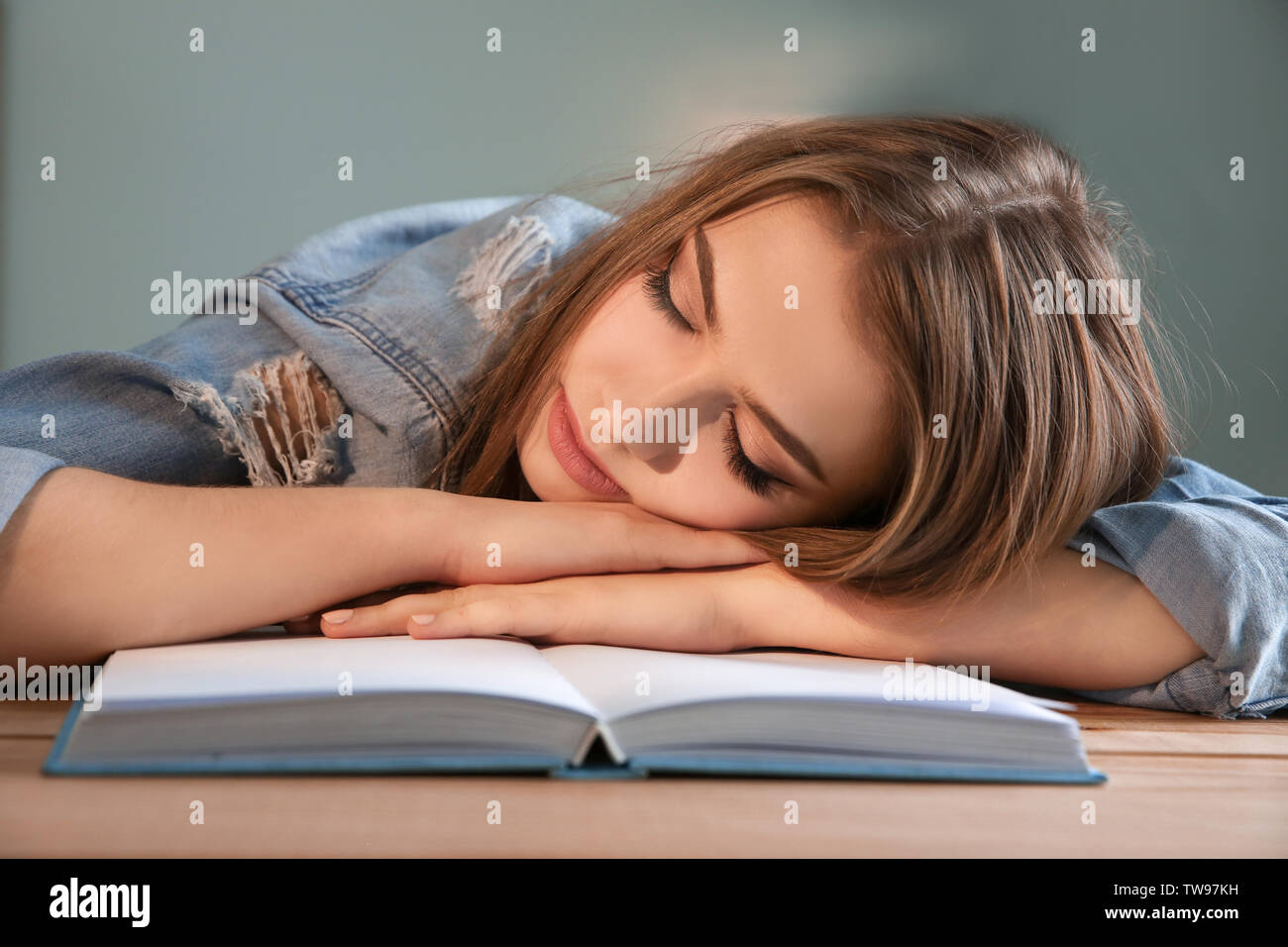 Tired student sleeping at her desk. Preparing for exam Stock Photo