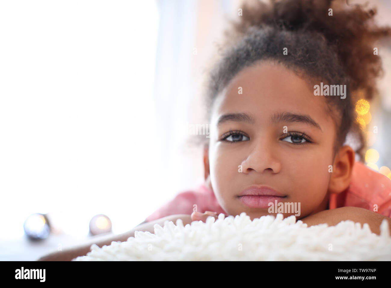 Cute African American girl lying on bed Stock Photo - Alamy