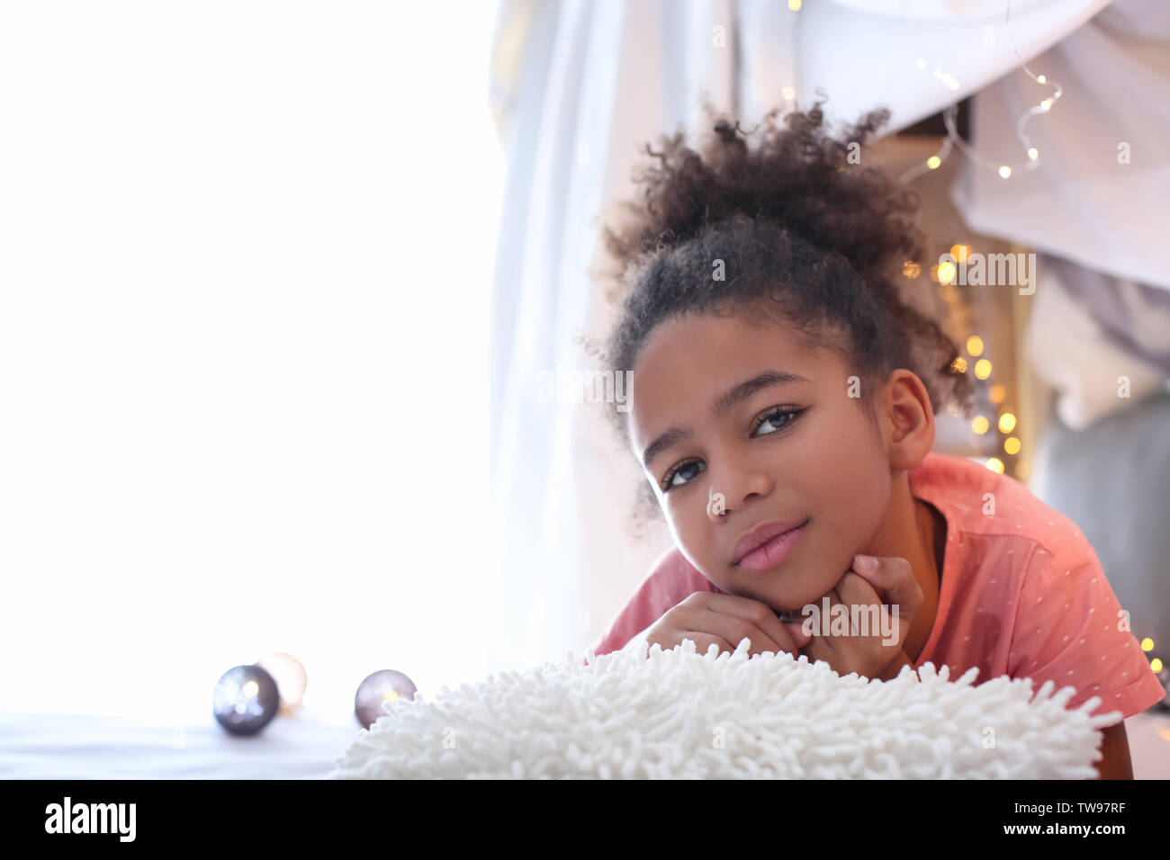 Cute African American girl lying on bed Stock Photo - Alamy