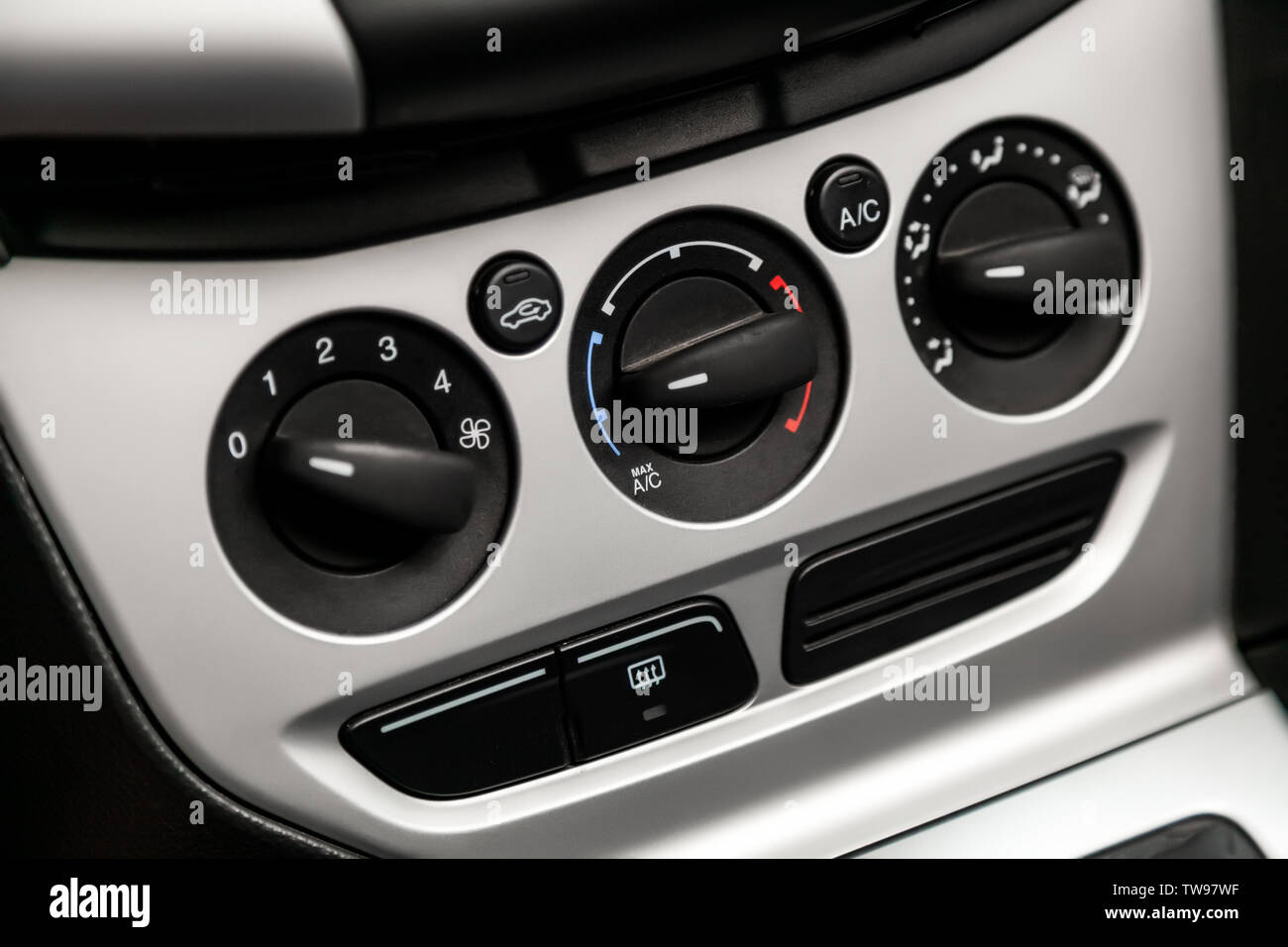 Black detail with the air conditioning button, inside a car. Close up