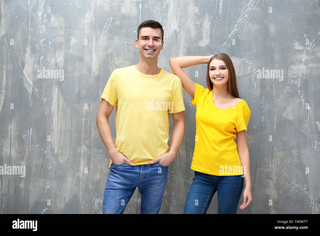 Download Young Woman And Man In Yellow T Shirts On Grunge Background Mockup For Design Stock Photo Alamy PSD Mockup Templates
