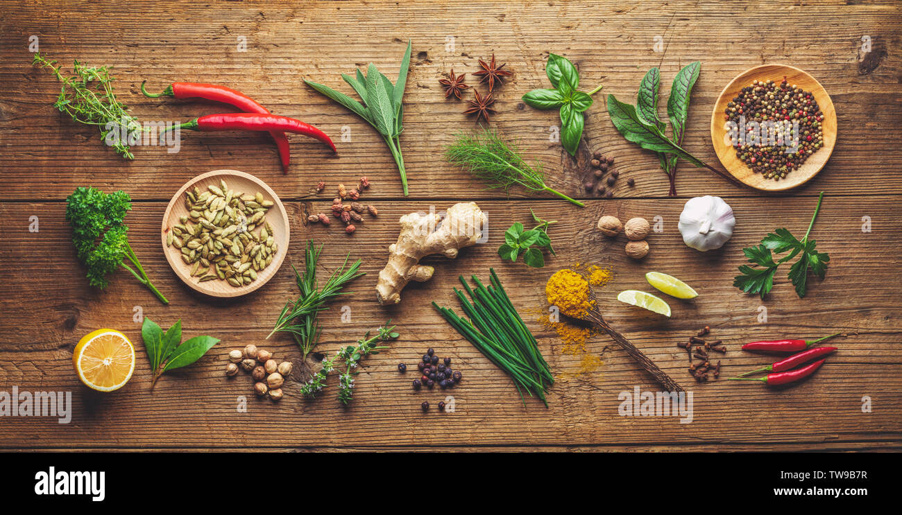 composition of various herbs and spices on wooden background Stock Photo