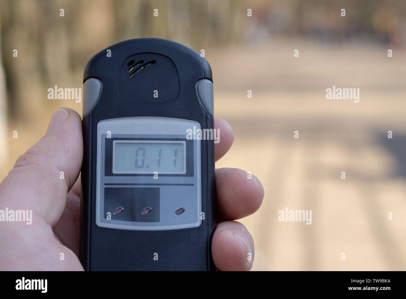 A man holds a device to measure the level of radiation Stock Photo Alamy
