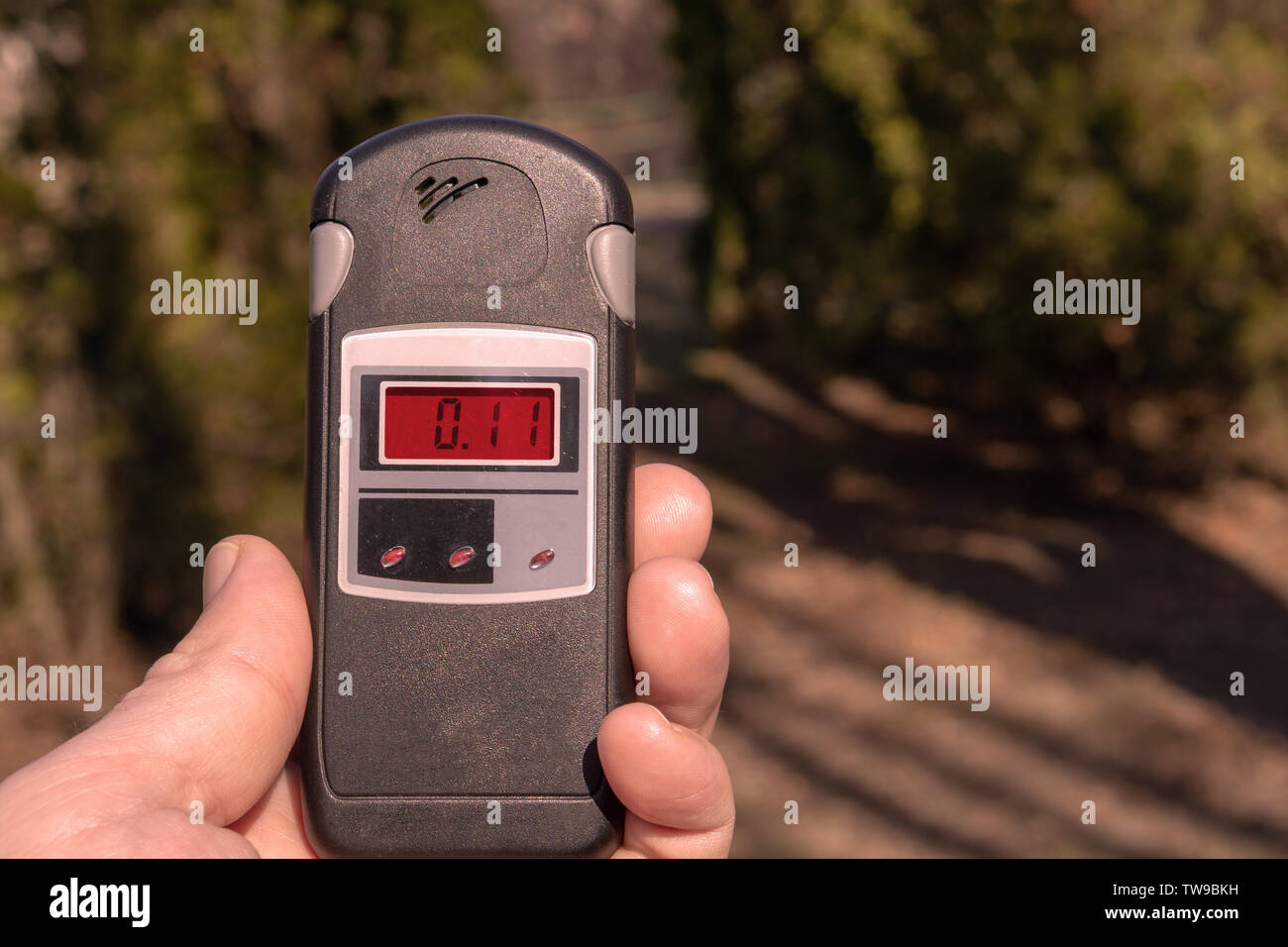 A man holds a device to measure the level of radiation Stock Photo Alamy