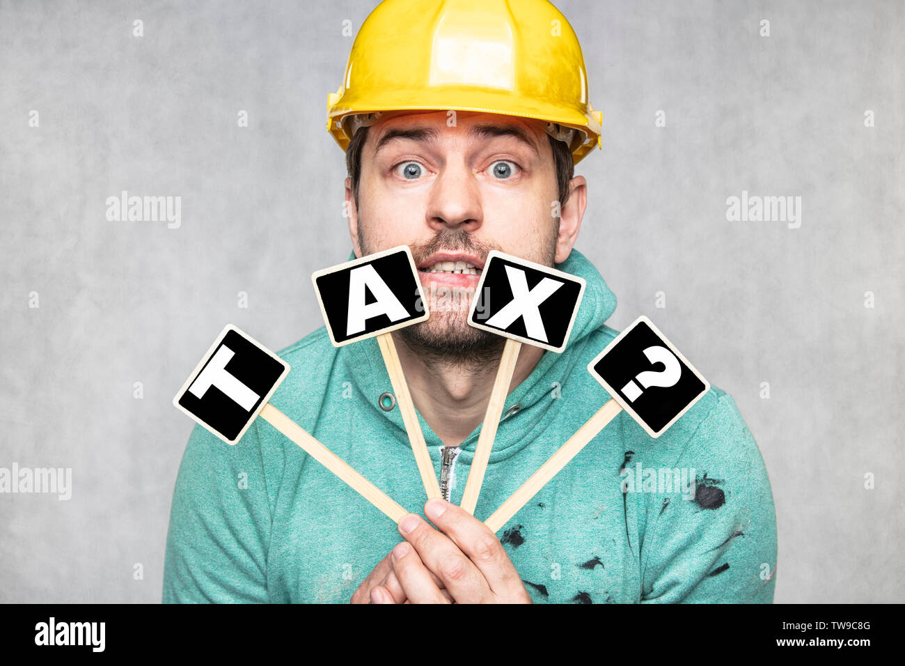 construction worker holding a blackboard with space for text or text, copy space, Stock Photo