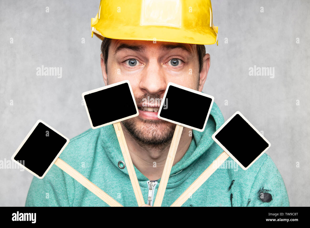 construction worker holding a blackboard with space for text or text, copy space, Stock Photo