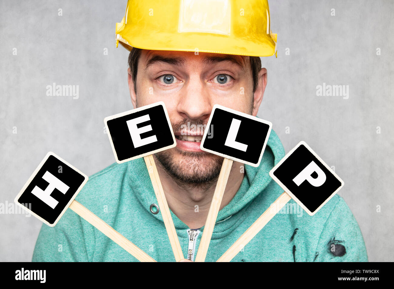 construction worker holding a blackboard with space for text or text, copy space, Stock Photo