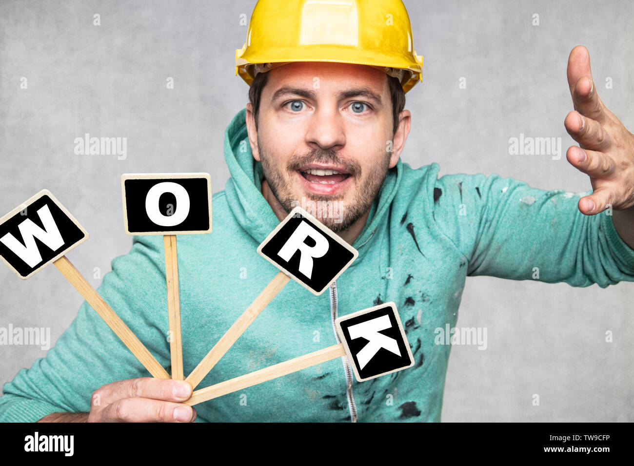 construction worker holding a blackboard with space for text or text, copy space, Stock Photo