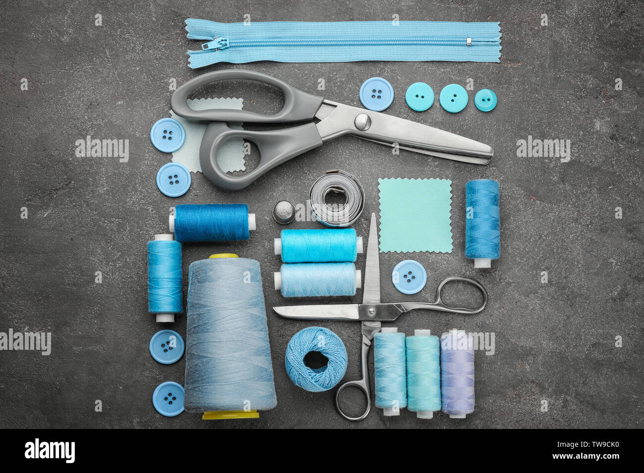 Colorful threads and sewing accessories on grey background Stock Photo ...