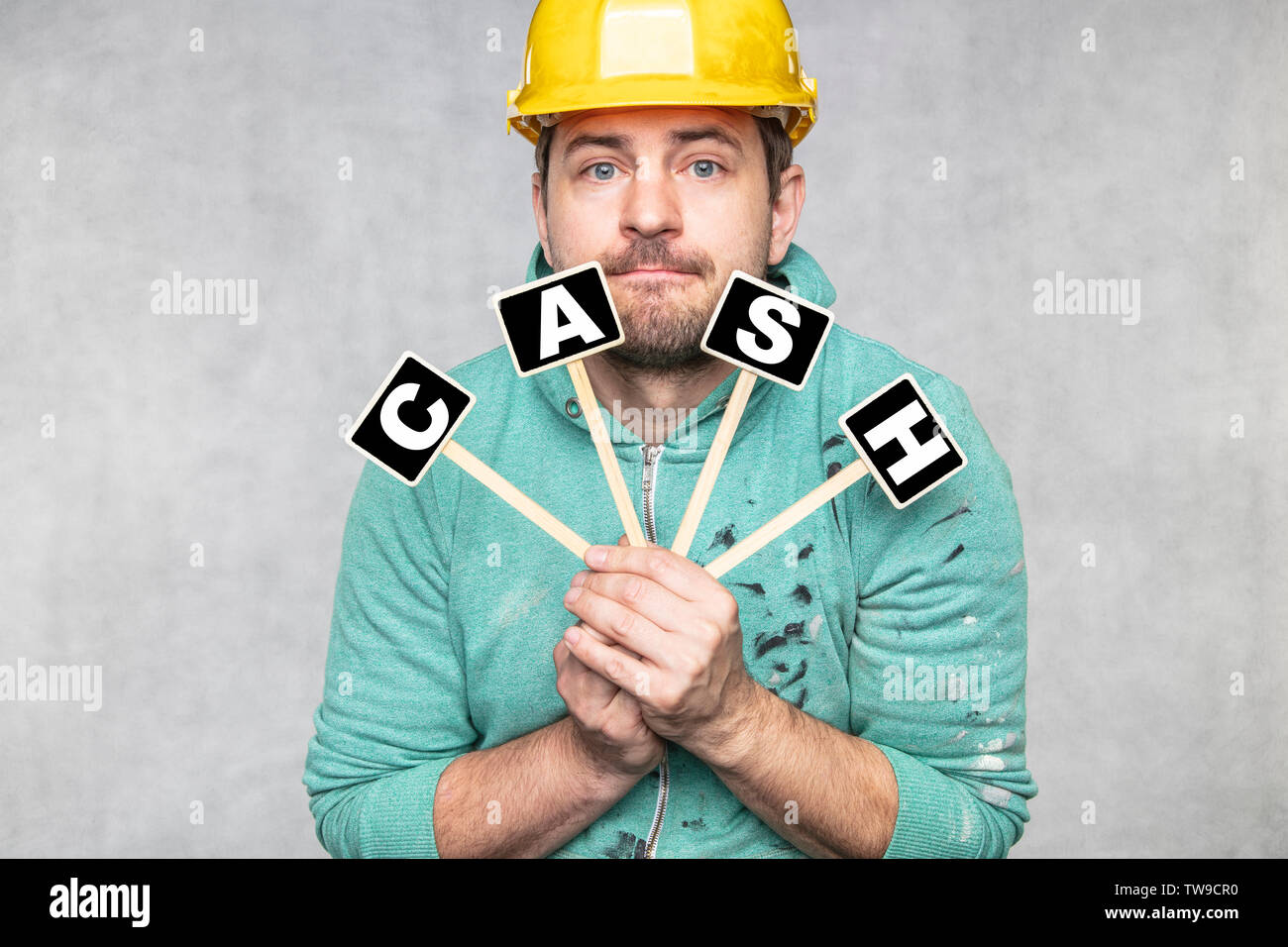 construction worker holding a blackboard with space for text or text, copy space, Stock Photo