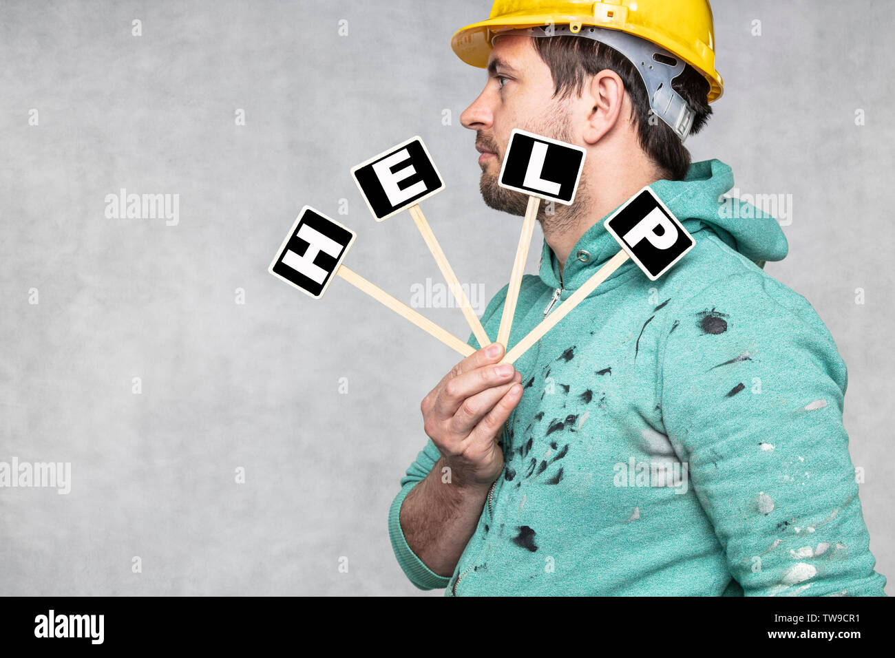 construction worker holding a blackboard with space for text or text, copy space, Stock Photo