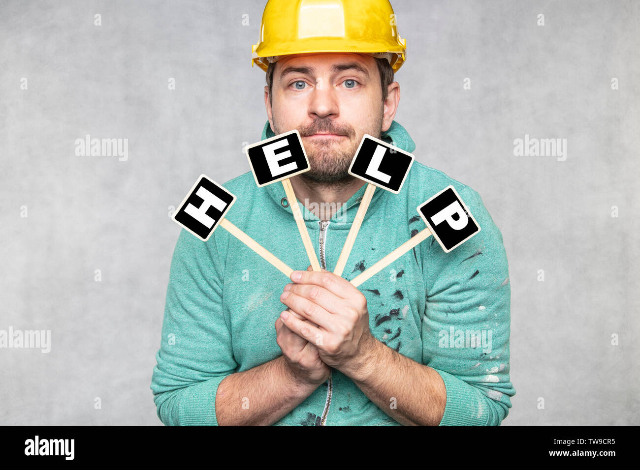 construction worker holding a blackboard with space for text or text, copy space, Stock Photo