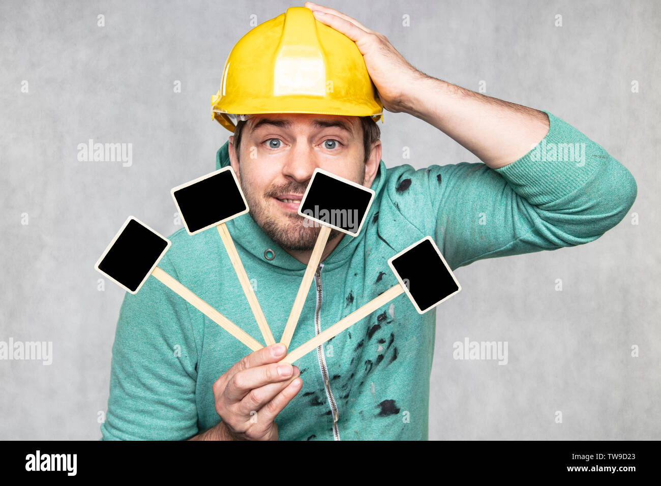 construction worker holding a blackboard with space for text or text, copy space, Stock Photo