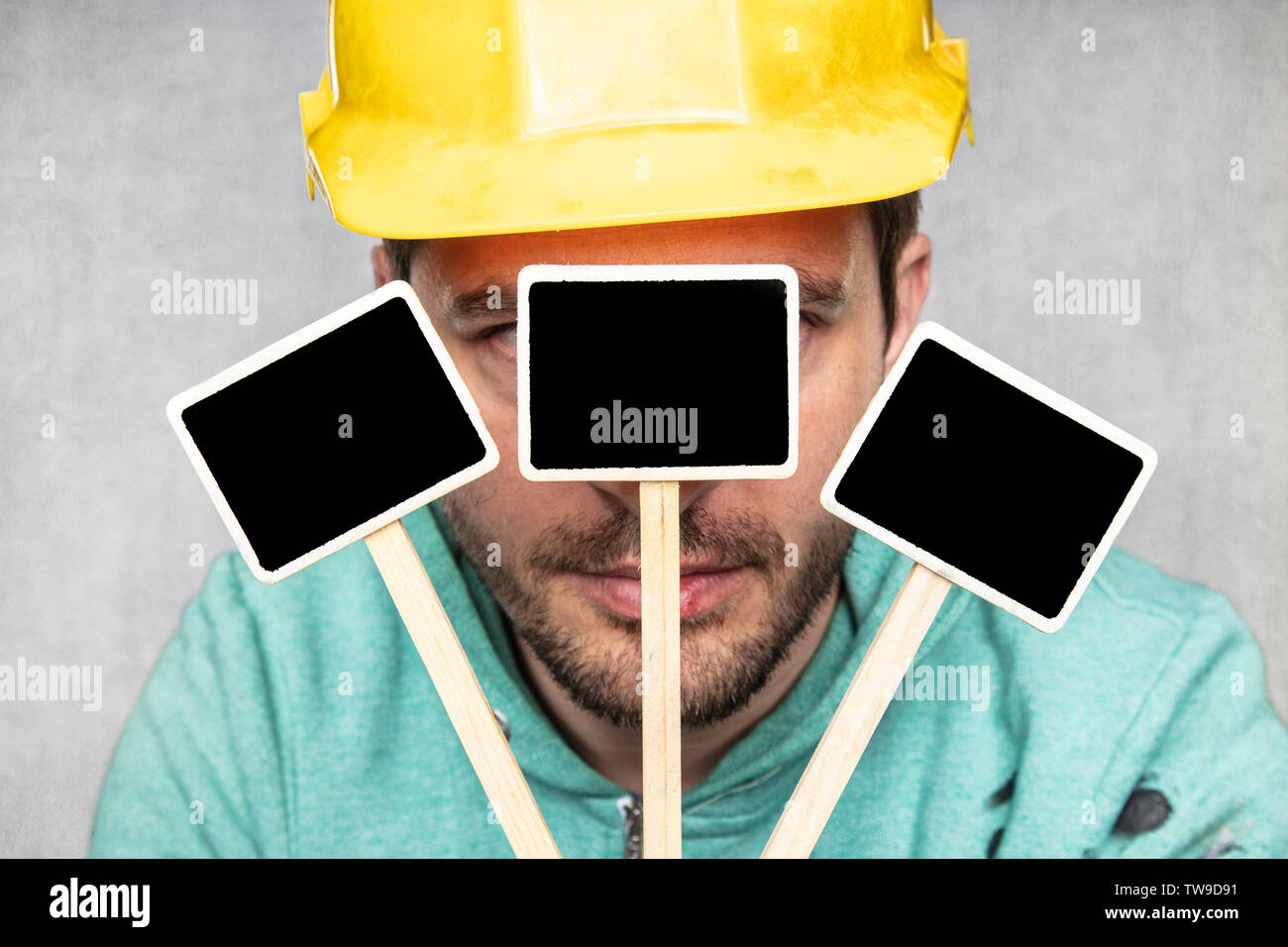construction worker holding a blackboard with space for text or text, copy space Stock Photo