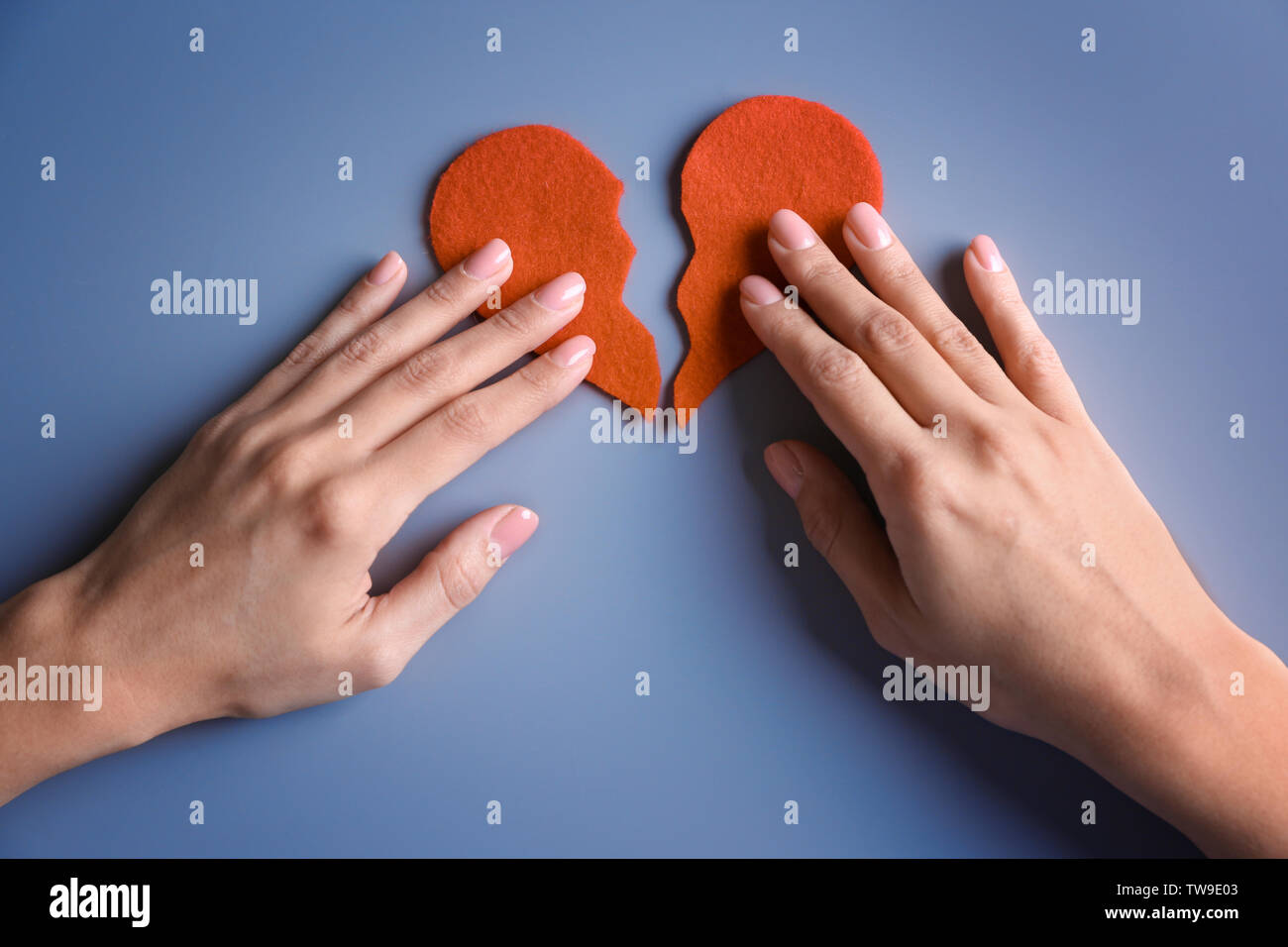 Hands holding half of red heart hi-res stock photography and images - Alamy