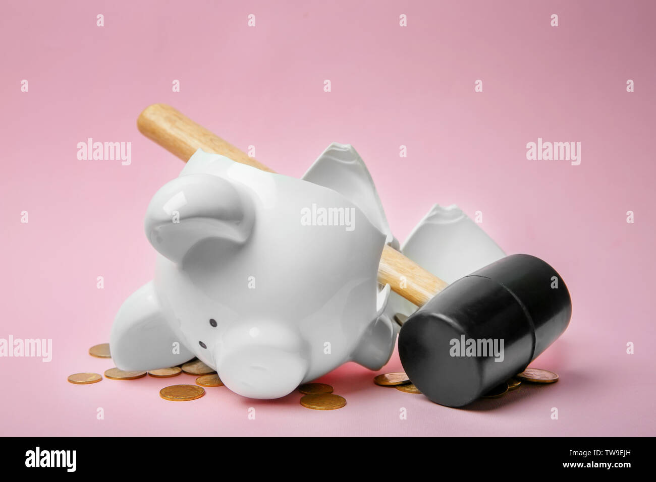 Broken piggy bank with money and hammer on color background Stock Photo ...