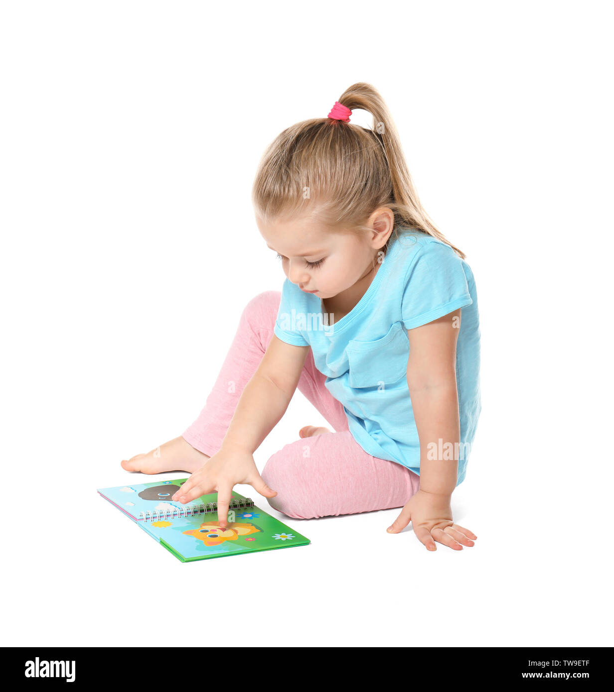 Cute little girl reading book on white background Stock Photo - Alamy