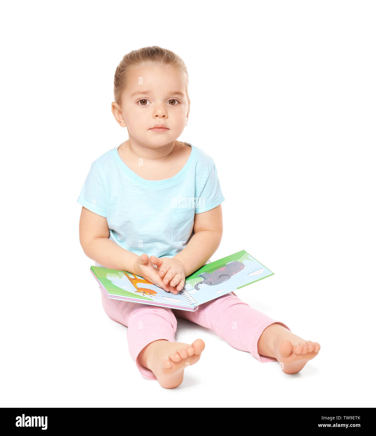 Cute little girl reading book on white background Stock Photo - Alamy