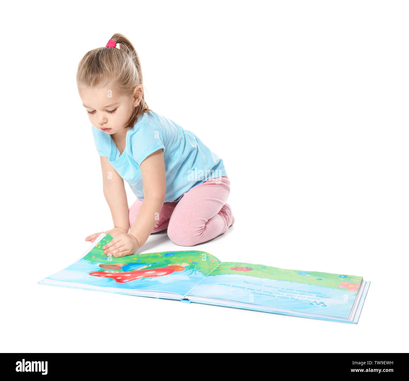 Cute little girl reading book on white background Stock Photo - Alamy