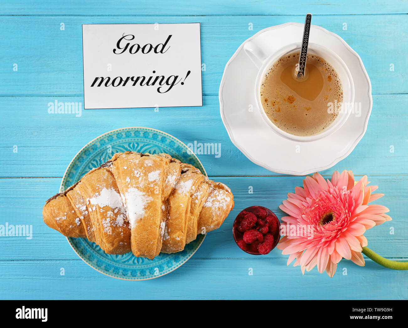 Plate With Croissant Cup Of Coffee And Flower On Table Top View