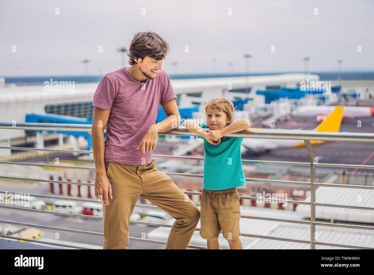 Family at airport before flight. Dad and son waiting to board at