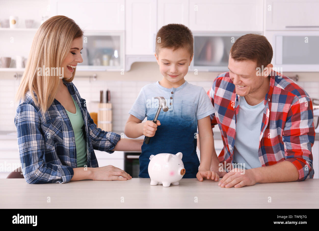 Happy family breaking piggy bank with hammer at home Stock Photo - Alamy