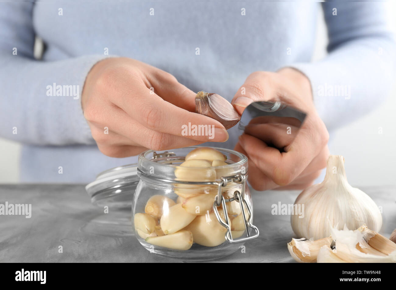 Woman peeling garlic hand on hi-res stock photography and images - Alamy