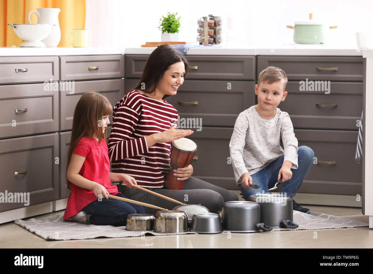 Family playing drums on kitchenware at home Stock Photo Alamy