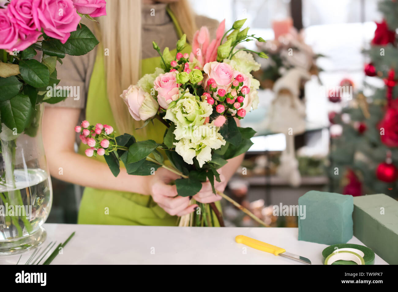 Female florist making beautiful bouquet in flower shop Stock Photo - Alamy