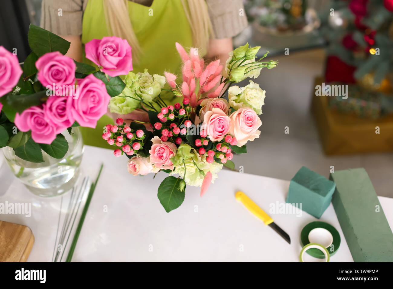 Female florist making beautiful bouquet in flower shop Stock Photo - Alamy