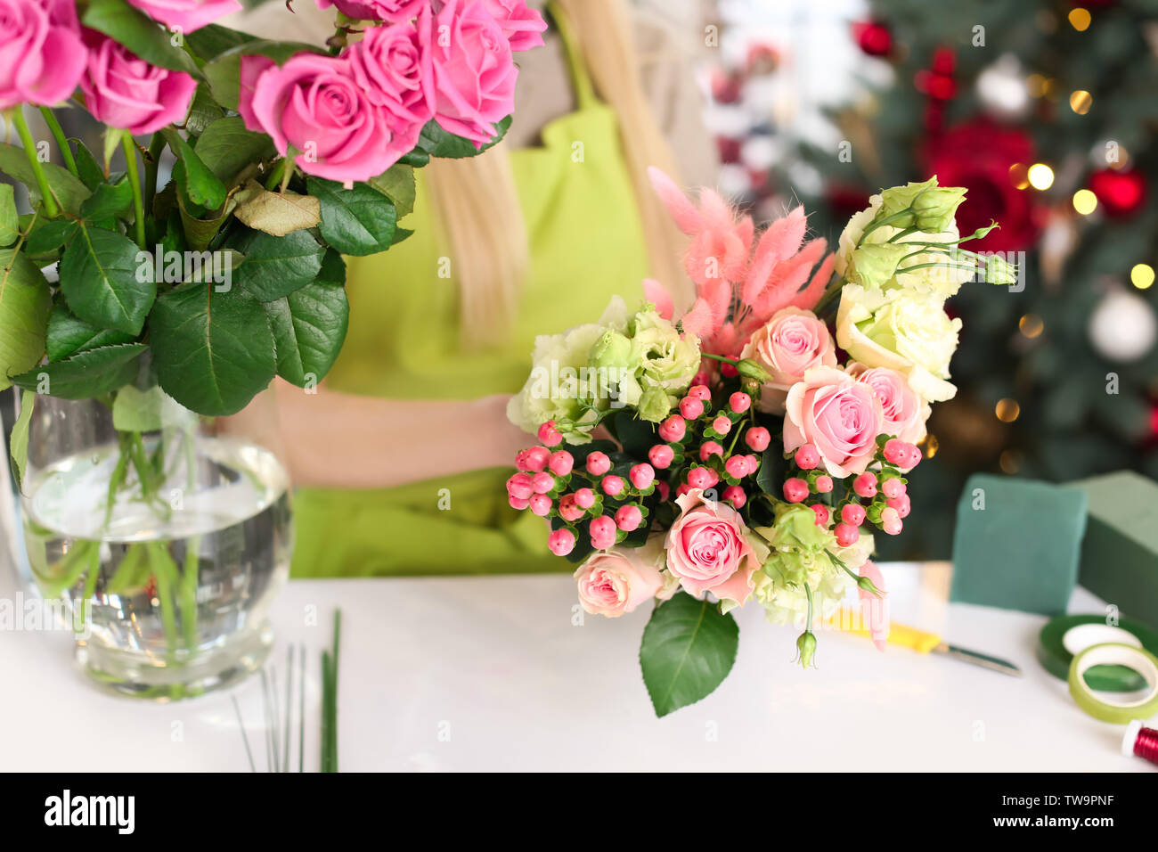 Female florist making beautiful bouquet in flower shop Stock Photo - Alamy