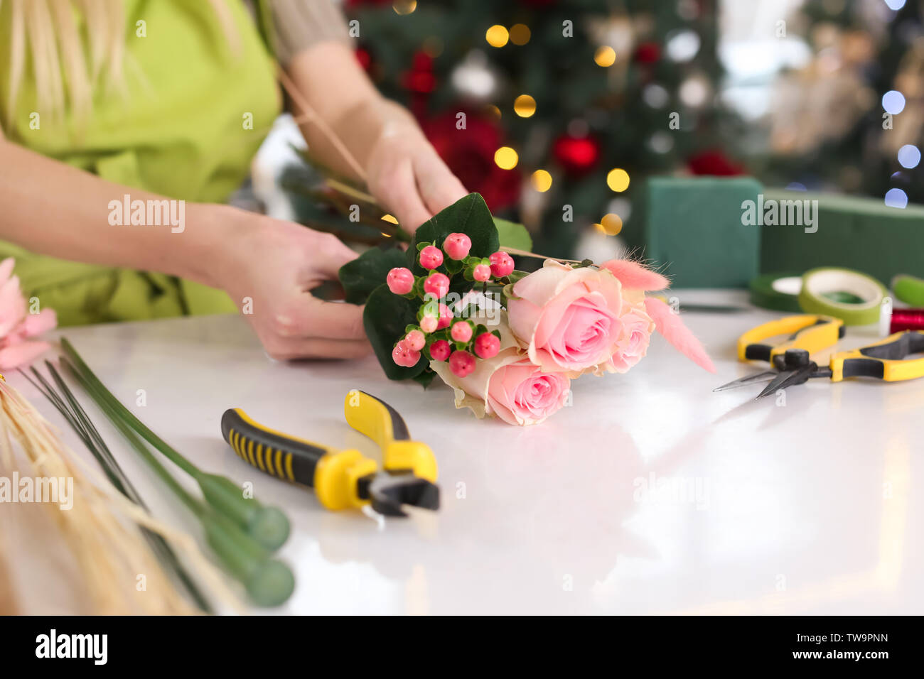 Female florist making beautiful bouquet in flower shop Stock Photo - Alamy