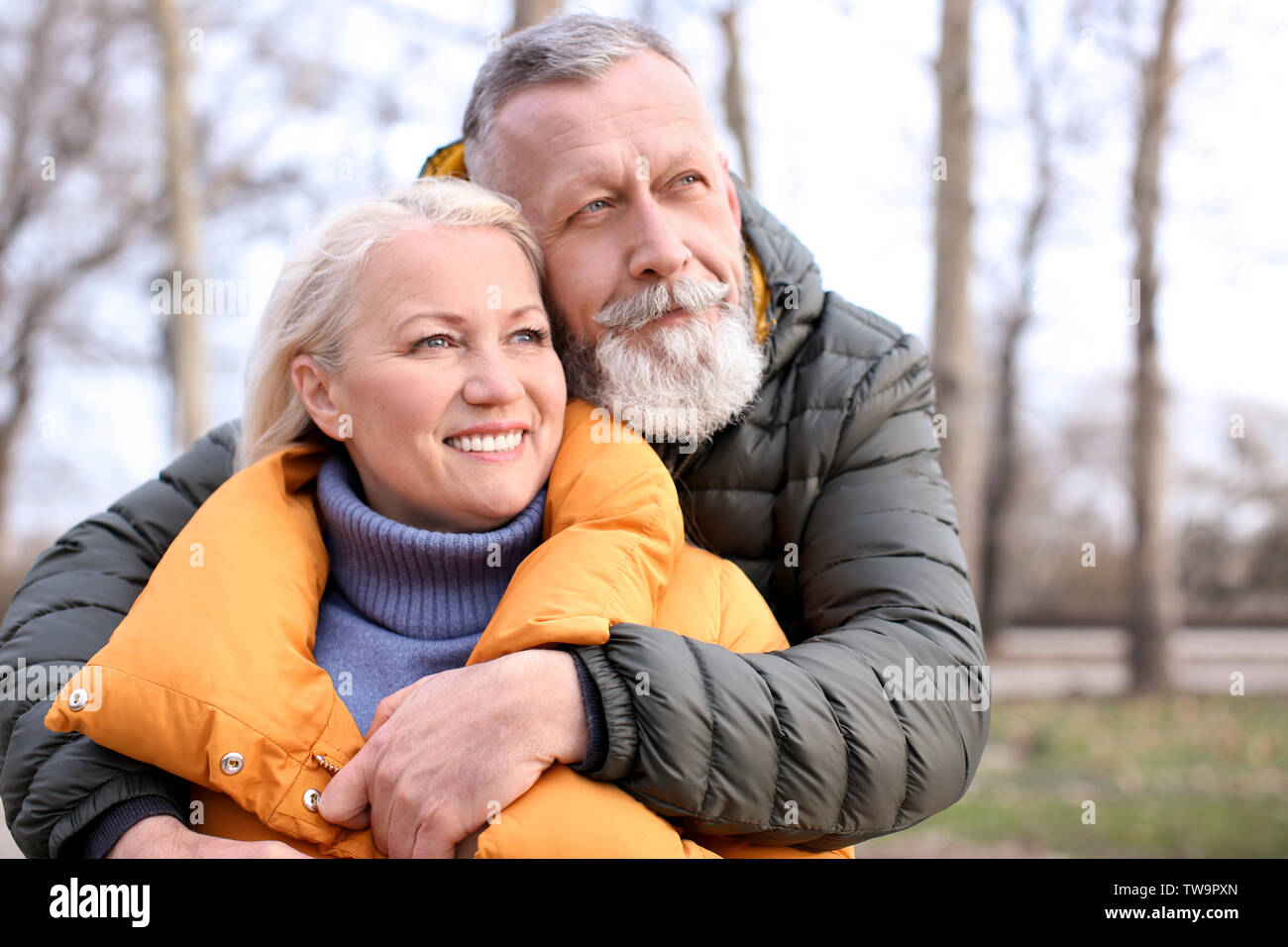 Happy mature couple hugging outdoors Stock Photo - Alamy