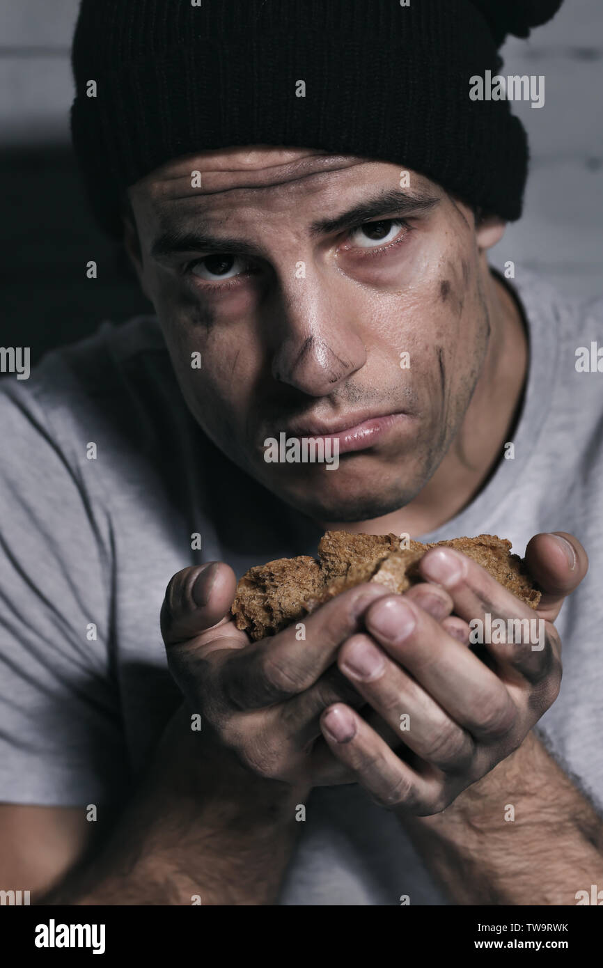 Homeless poor man with piece of bread Stock Photo - Alamy
