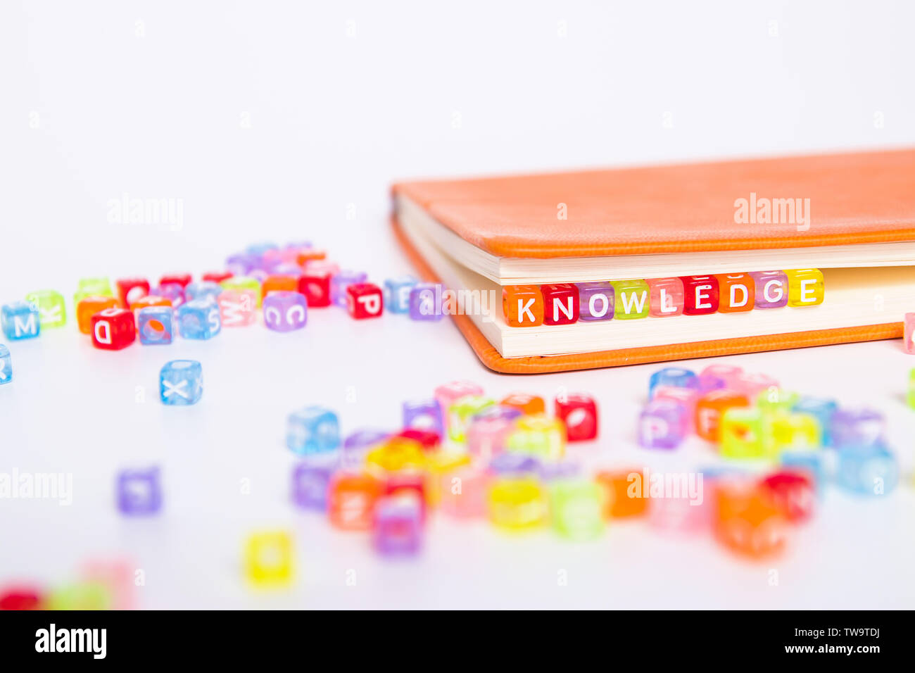 KNOWLEDGE word on colorful bead block as bookmark in book. education and knowledge concept Stock Photo