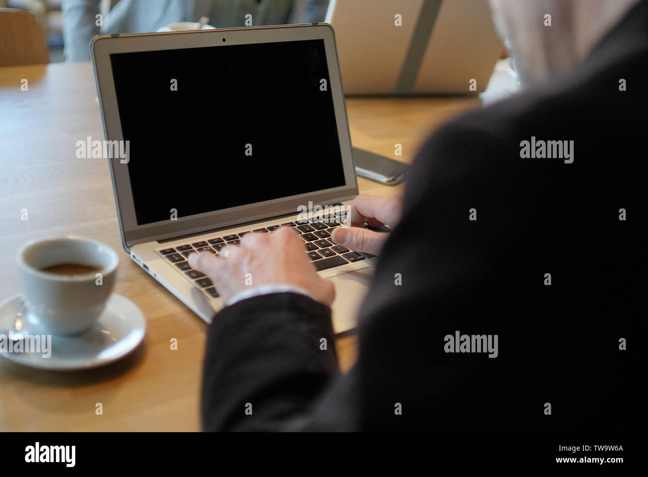 Businessman's hands on computer with blank screen Stock Photo